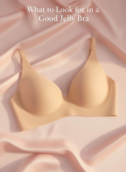 A clean, high-end product shot of a Jelly Bra resting on soft, satin-like silk fabric, utilizing a minimalist text hook for maximum clarity.